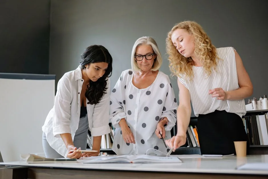 Hands discussing marketing strategy with charts in an office setting.